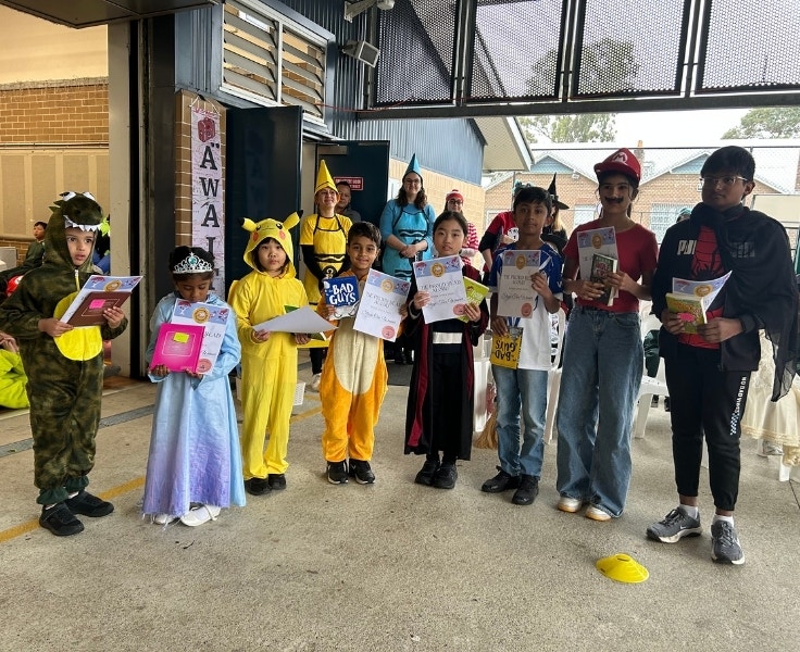 Students dressed in costumes holding books during a Book Week celebration.